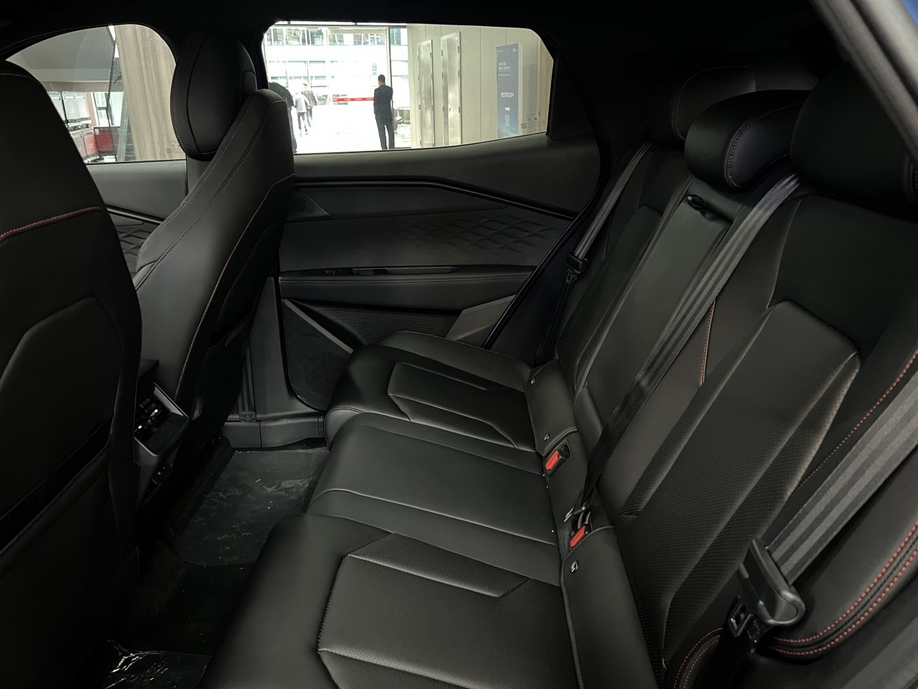 Black leather rear seats with modern door panel and stitching details