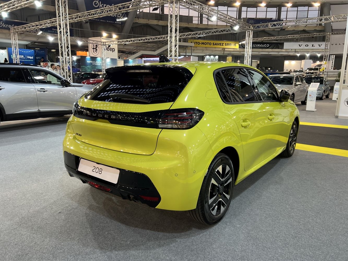 Rear view of a compact hatchback with blacked-out tail lights and a sporty bumper.