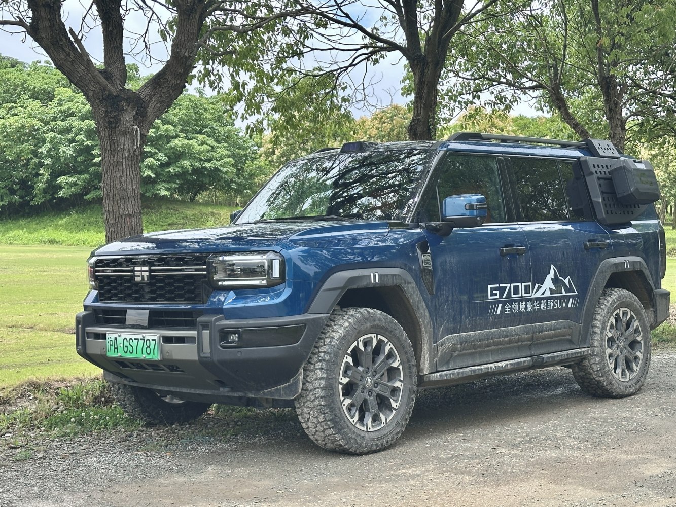 Rugged off-road SUV front side view with tires and side storage box