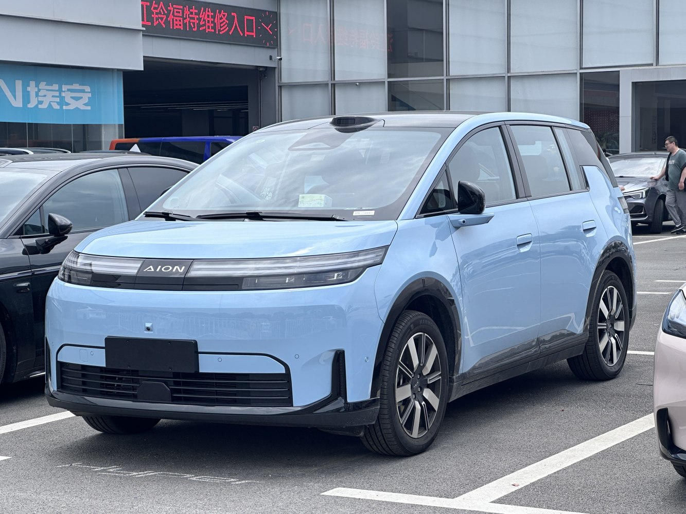 Front view of a futuristic blue electric crossover with LED headlights
