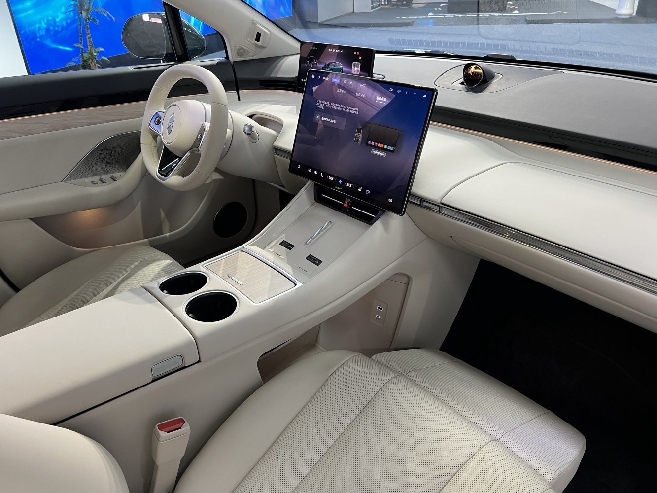Modern car interior with large touchscreen display and beige upholstery