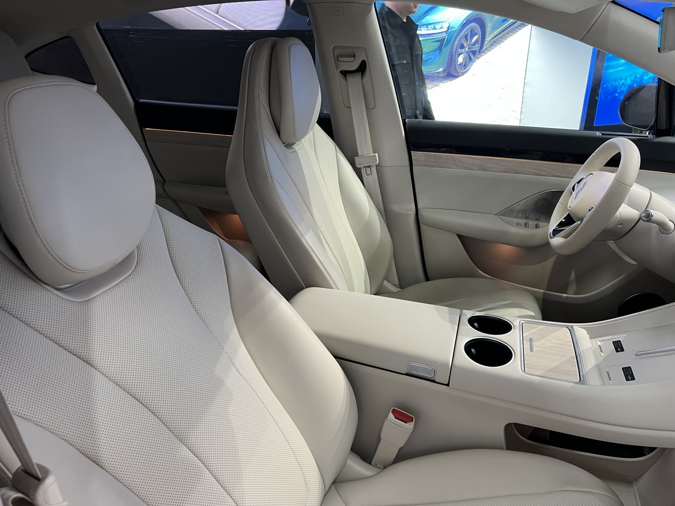 Beige leather front seats with sleek center console and door trim