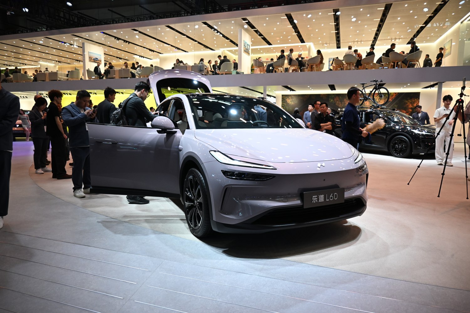 Front view of sleek car with LED headlights and open driver door