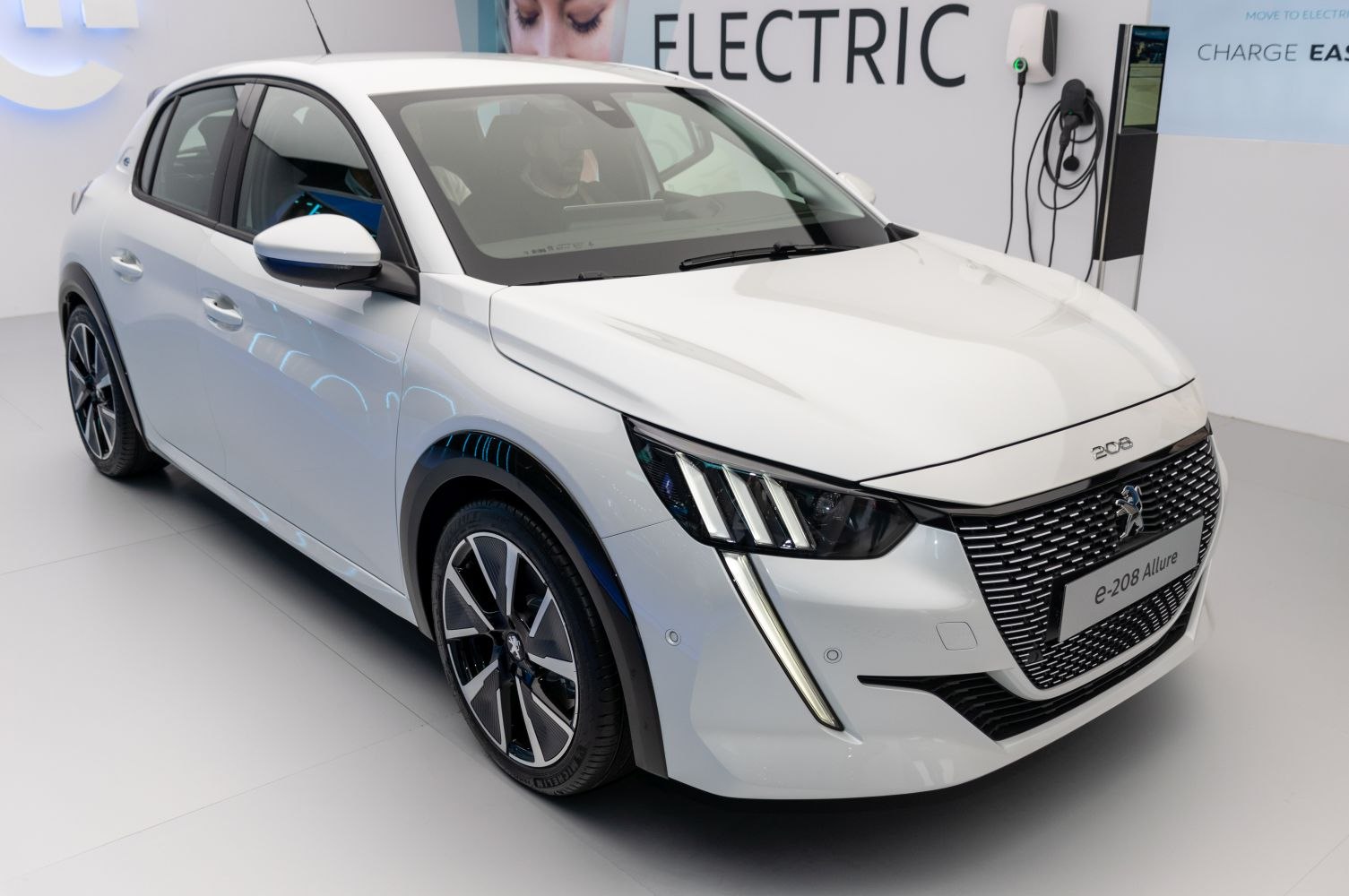 Front view of white electric hatchback with LED headlights and distinctive grille