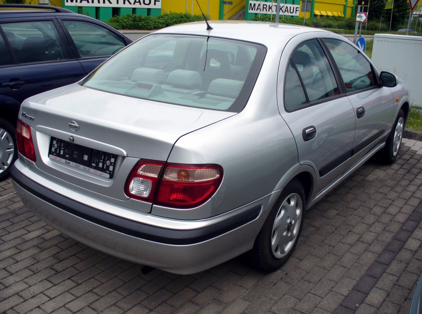Silver sedan rear view with distinct taillights and rear design