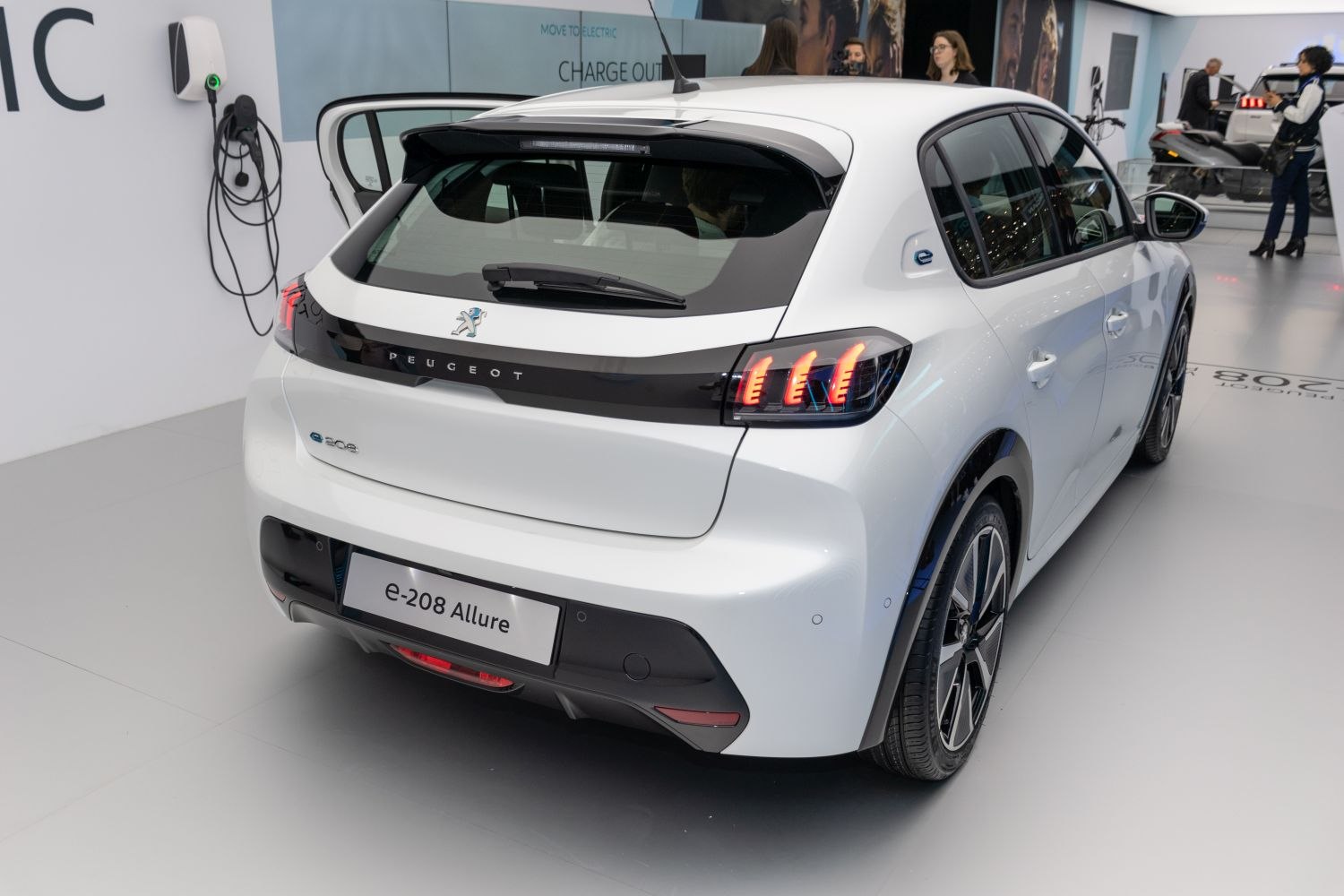 Rear hatchback view with distinctive vertical LED tail lights and electric model badge