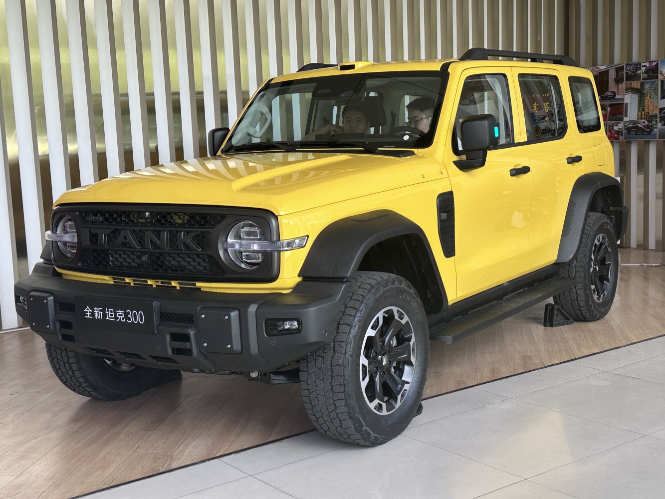 Yellow SUV with rugged grille, round headlights, off-road tires
