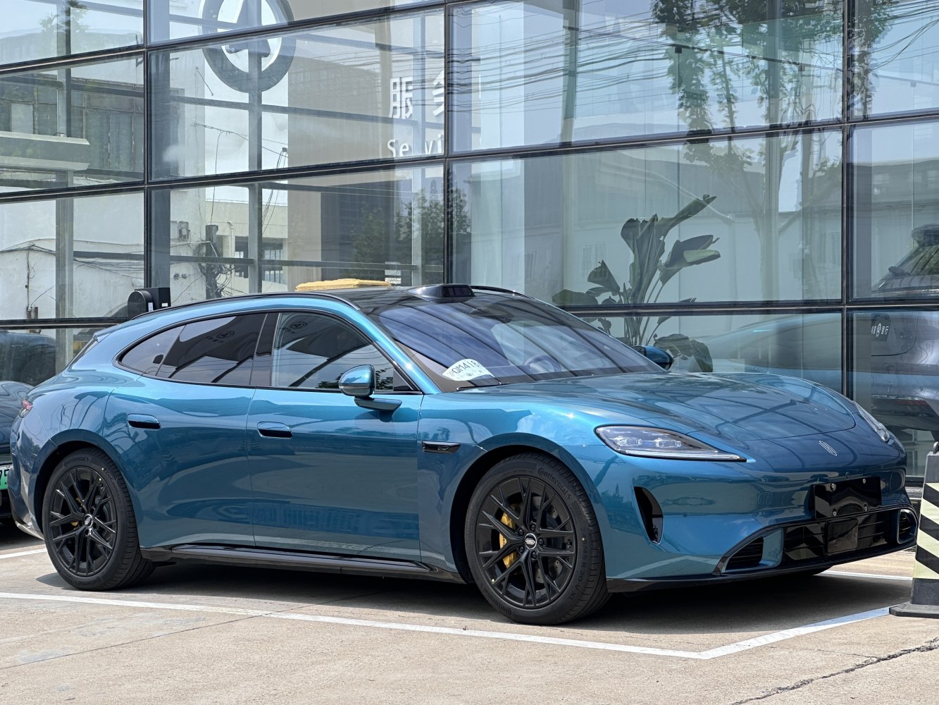 Sleek electric luxury sports shooting brake with black alloy wheels