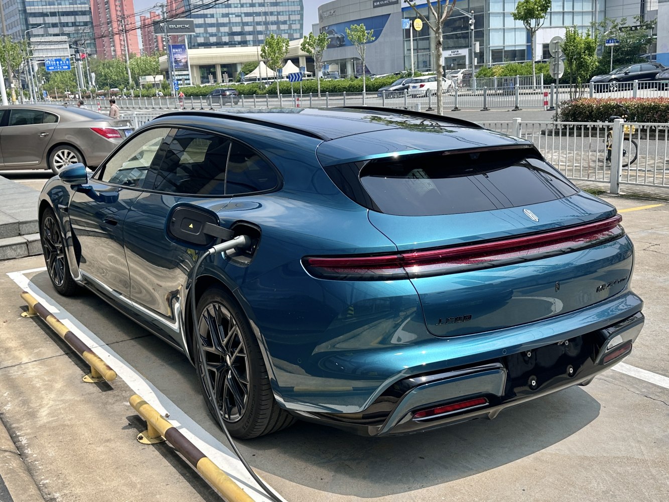 Electric vehicle charging with sleek rear and full-width taillight bar