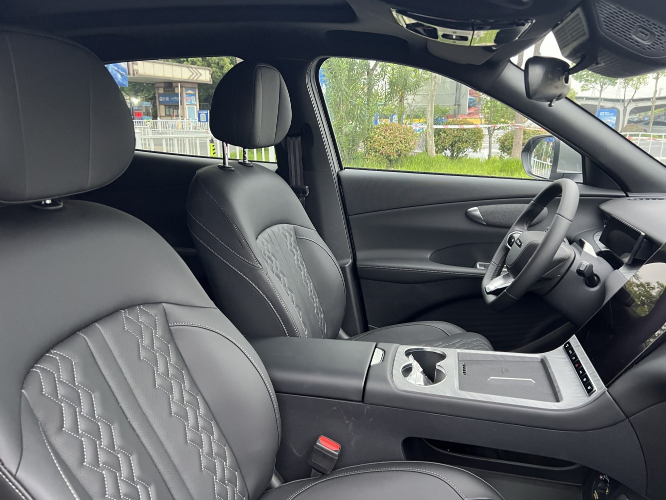 Black leather seats with diamond stitching and modern dashboard display