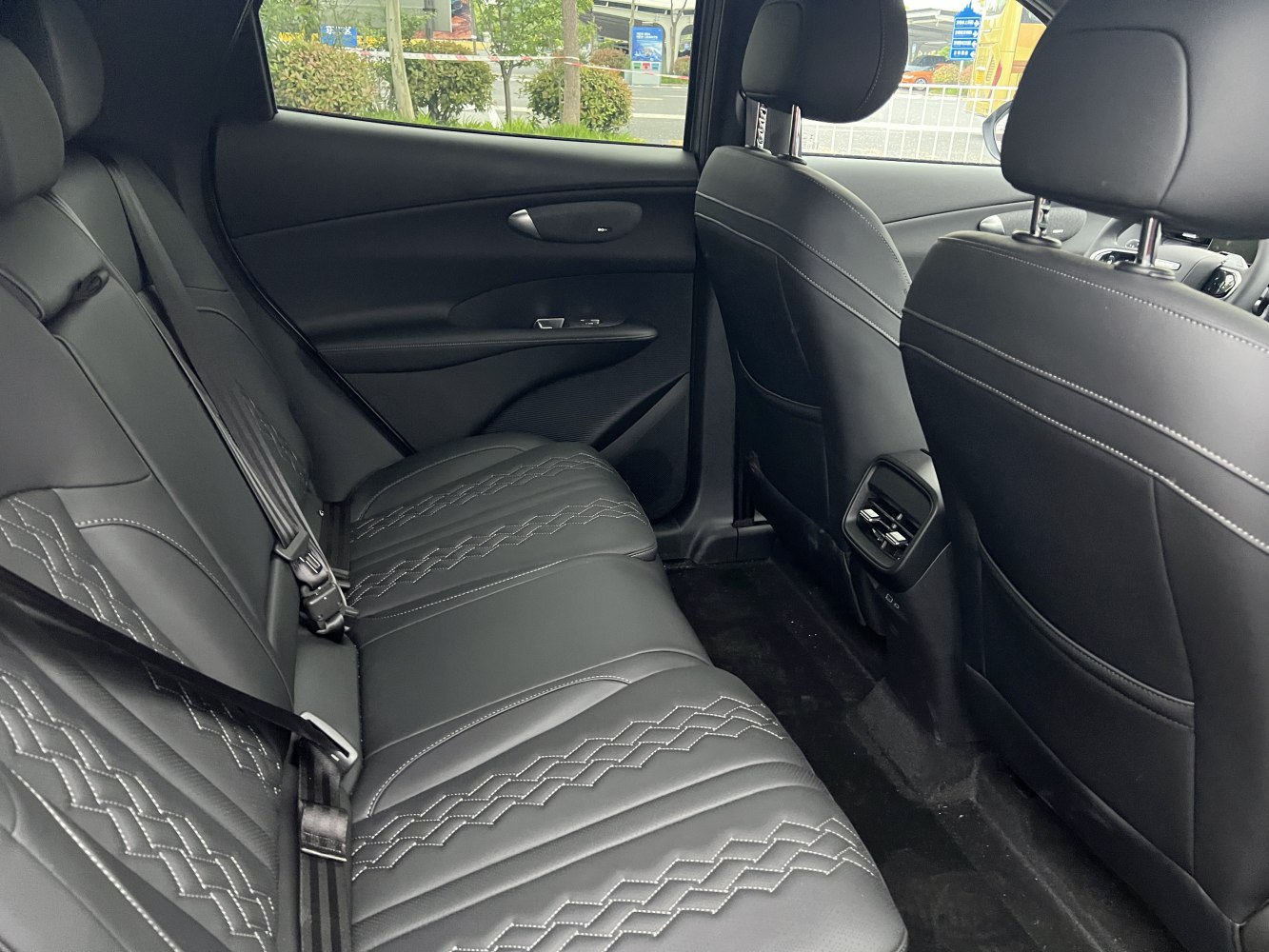 Black leather rear seats with decorative stitching and rear air vents