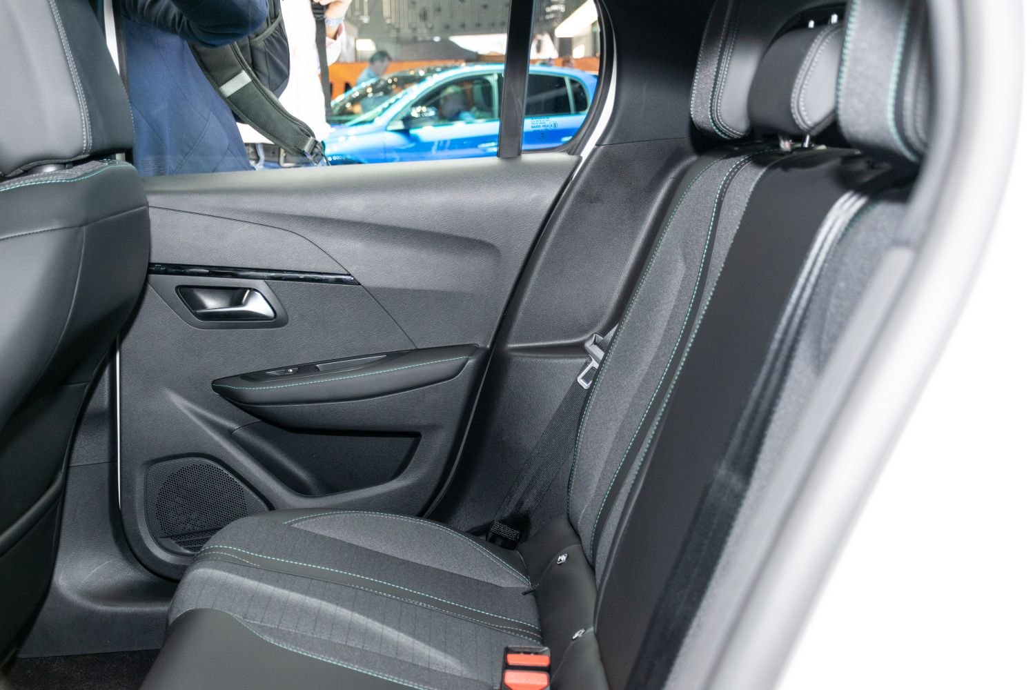 Rear passenger seat and door panel with upholstery and window