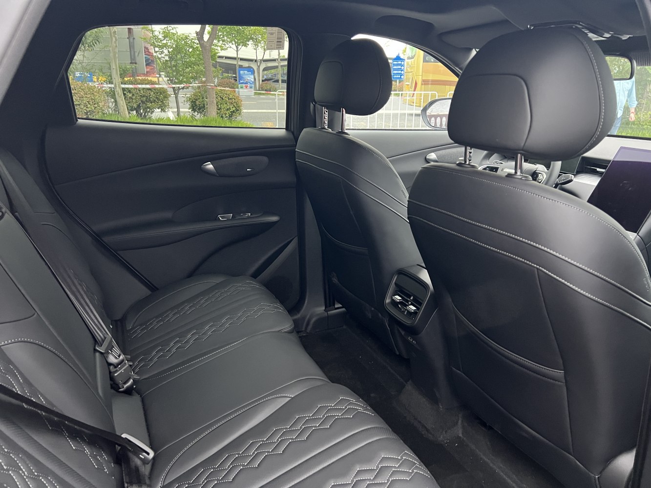 Rear black quilted leather seats with air vents and detailed stitching