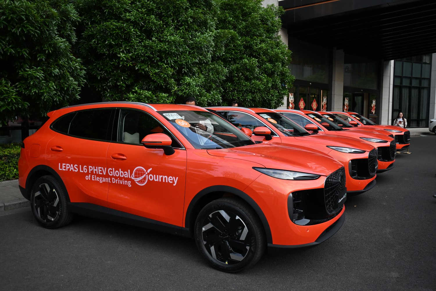 Bright orange PHEV SUVs with aerodynamic design and black grille.