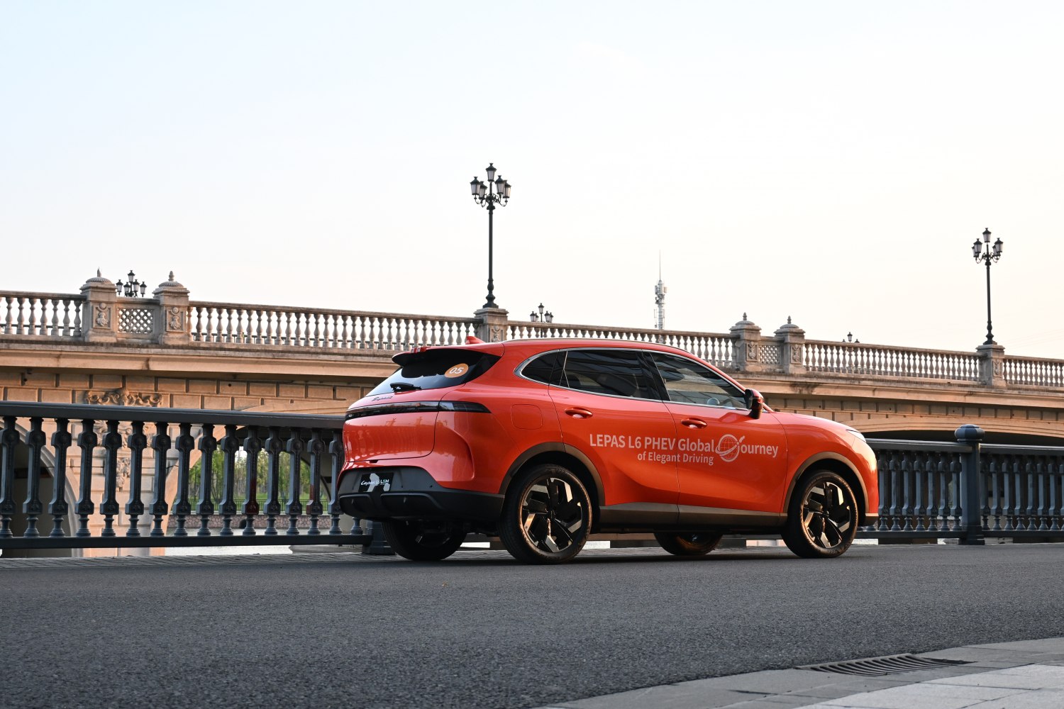 Orange coupe SUV side profile with tinted windows and modern wheels