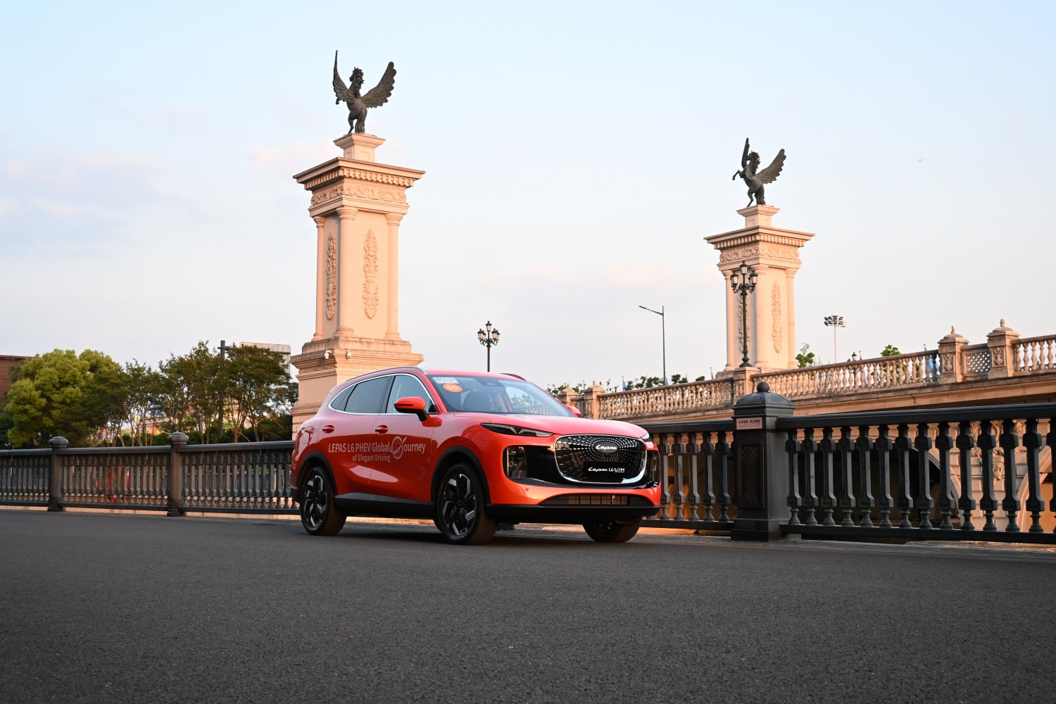 Red SUV front view with alloy wheels on city bridge