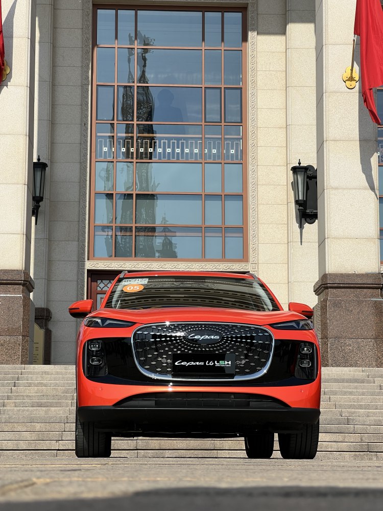 Front grille and sleek headlight design of a modern car.