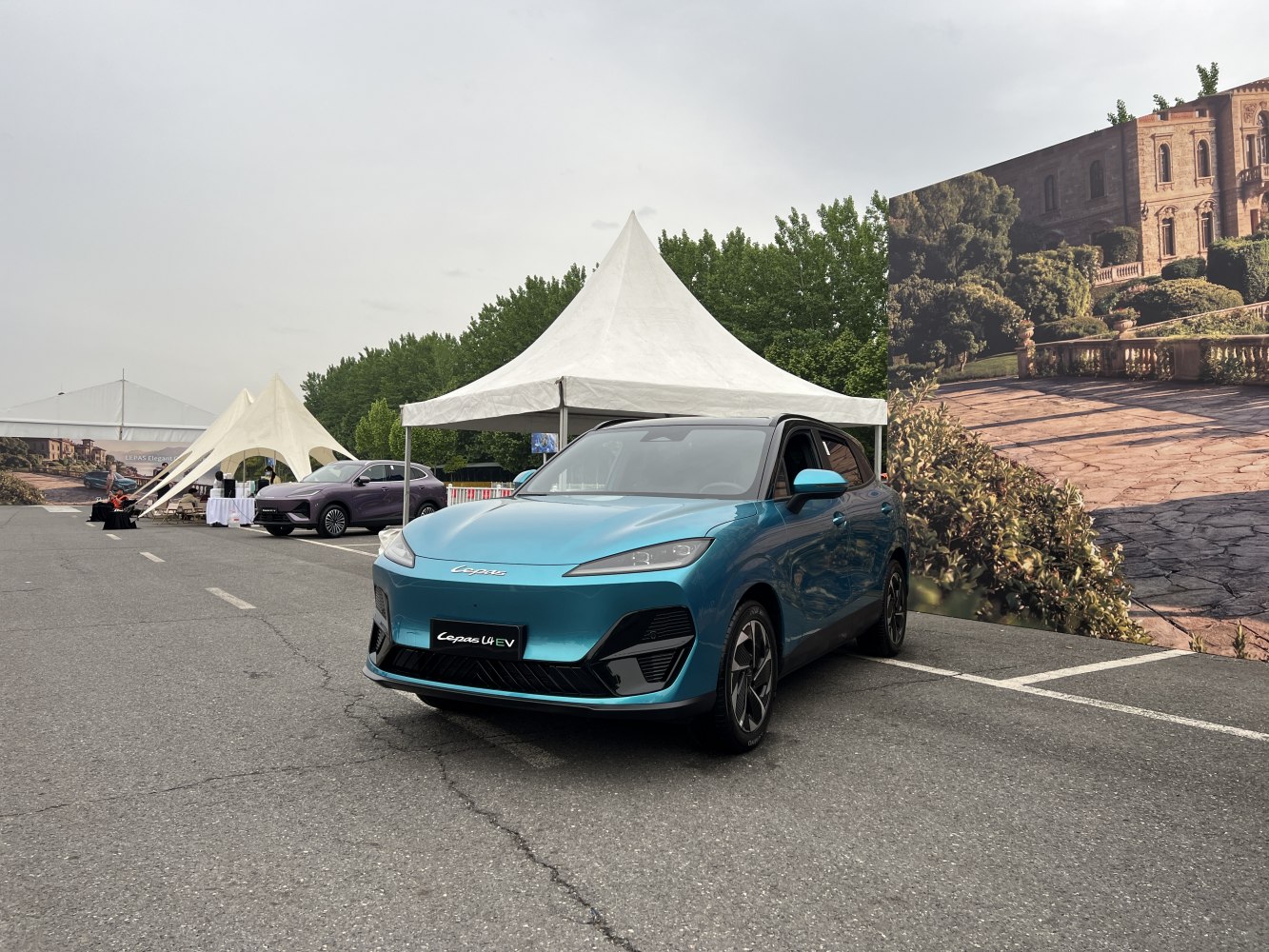 Sleek front view of blue electric SUV with sharp headlights and aerodynamic design