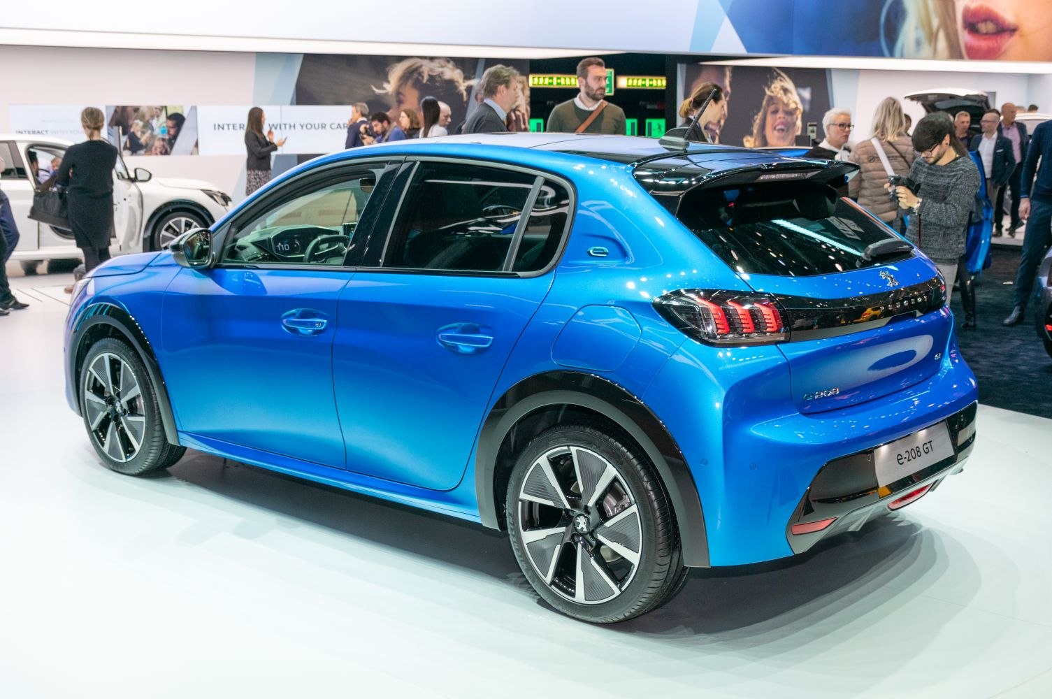 Rear side view of blue hatchback showing taillights and alloy wheels.