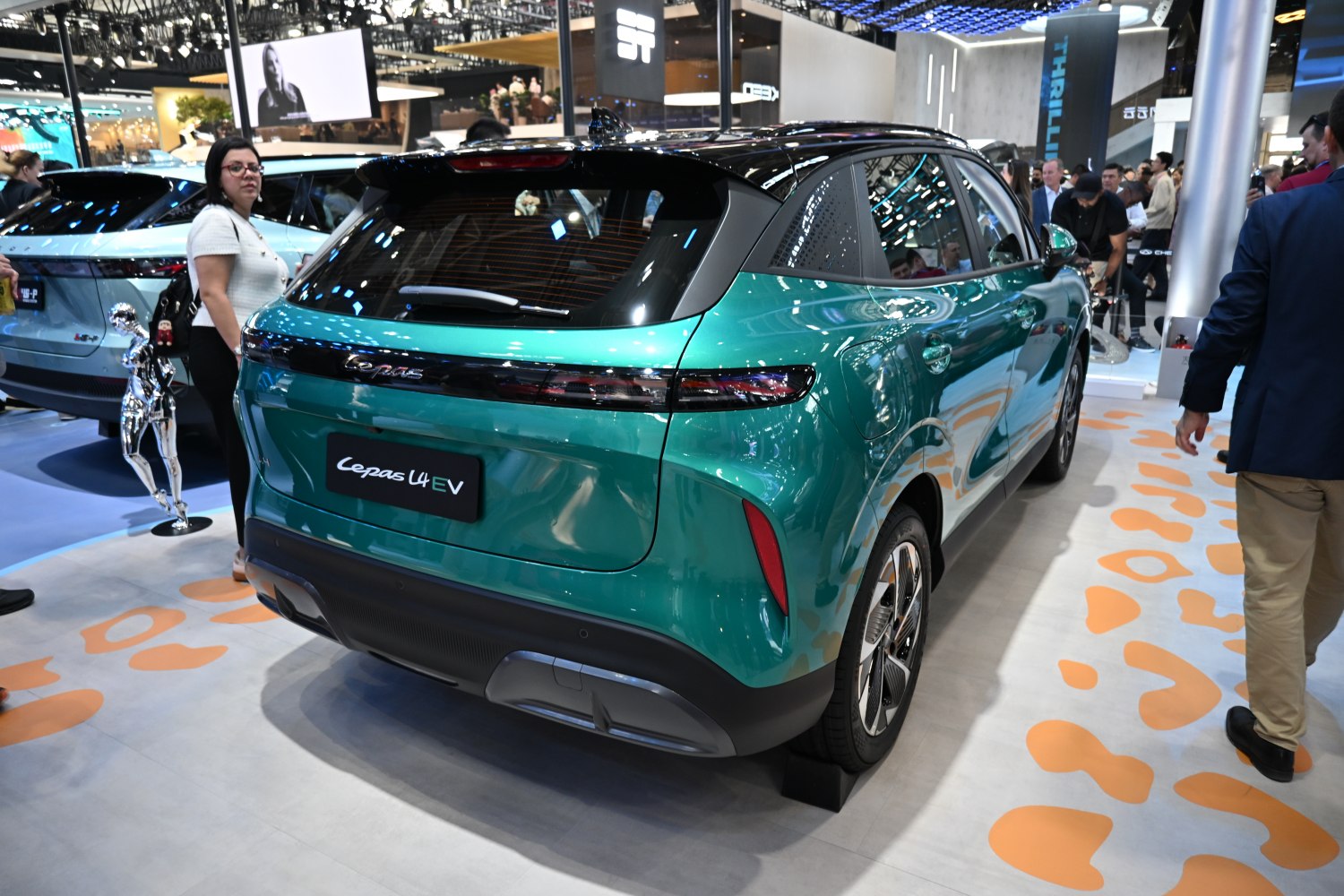 Rear view of green electric vehicle with LED taillights and modern styling
