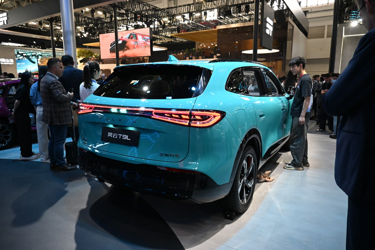 Rear view of an SUV with continuous LED light bar and aqua blue color