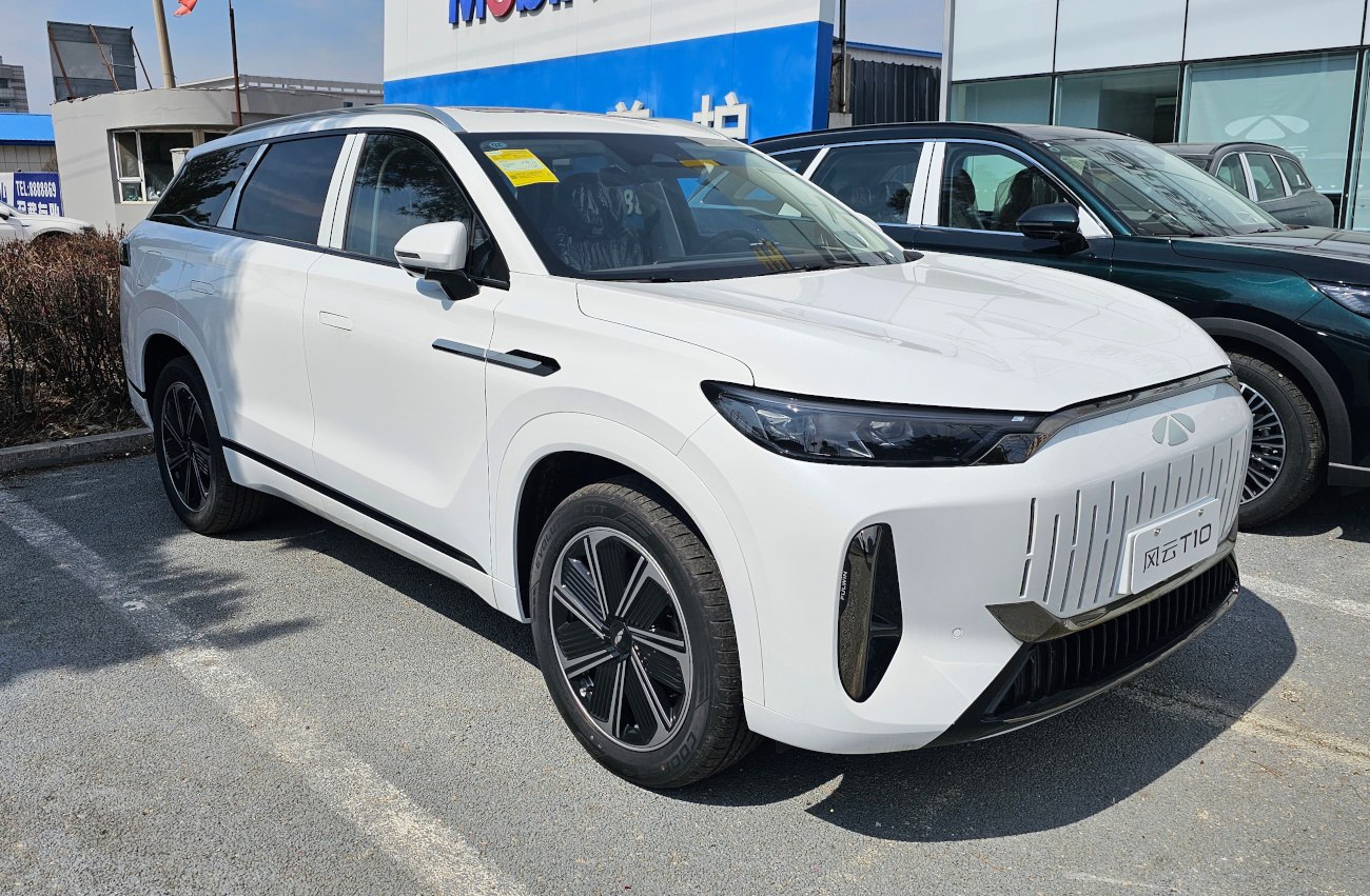 White electric SUV with LED headlights and aerodynamic grille
