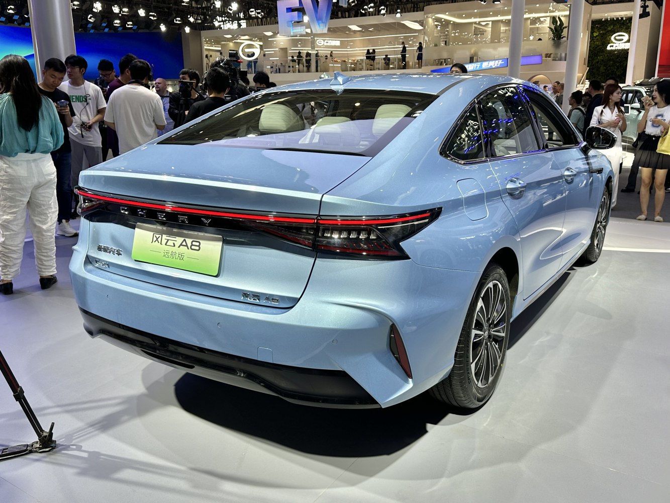 Rear view of a sedan with continuous LED tail light strip.