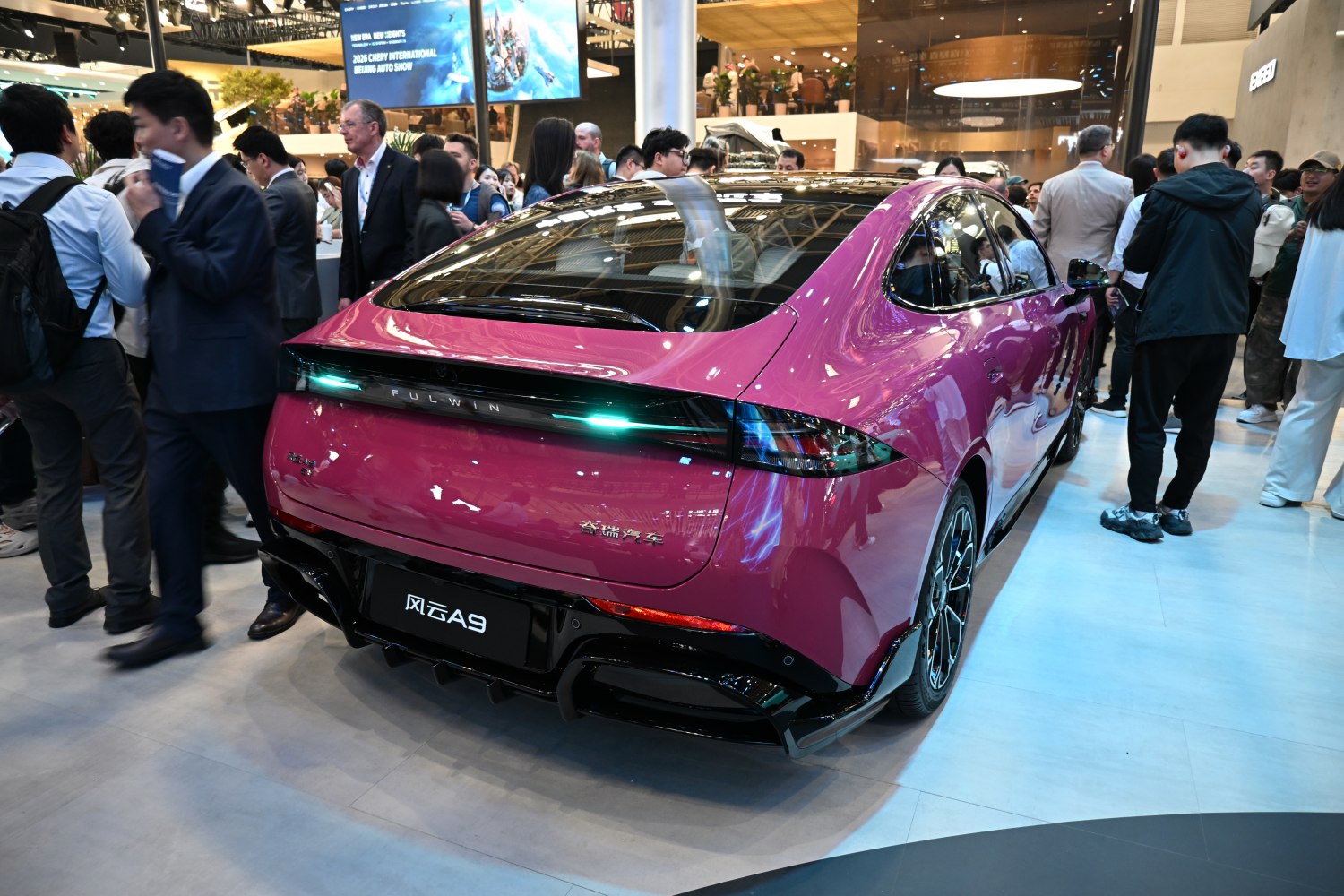 Sleek car rear with LED taillight strip and sporty diffuser.