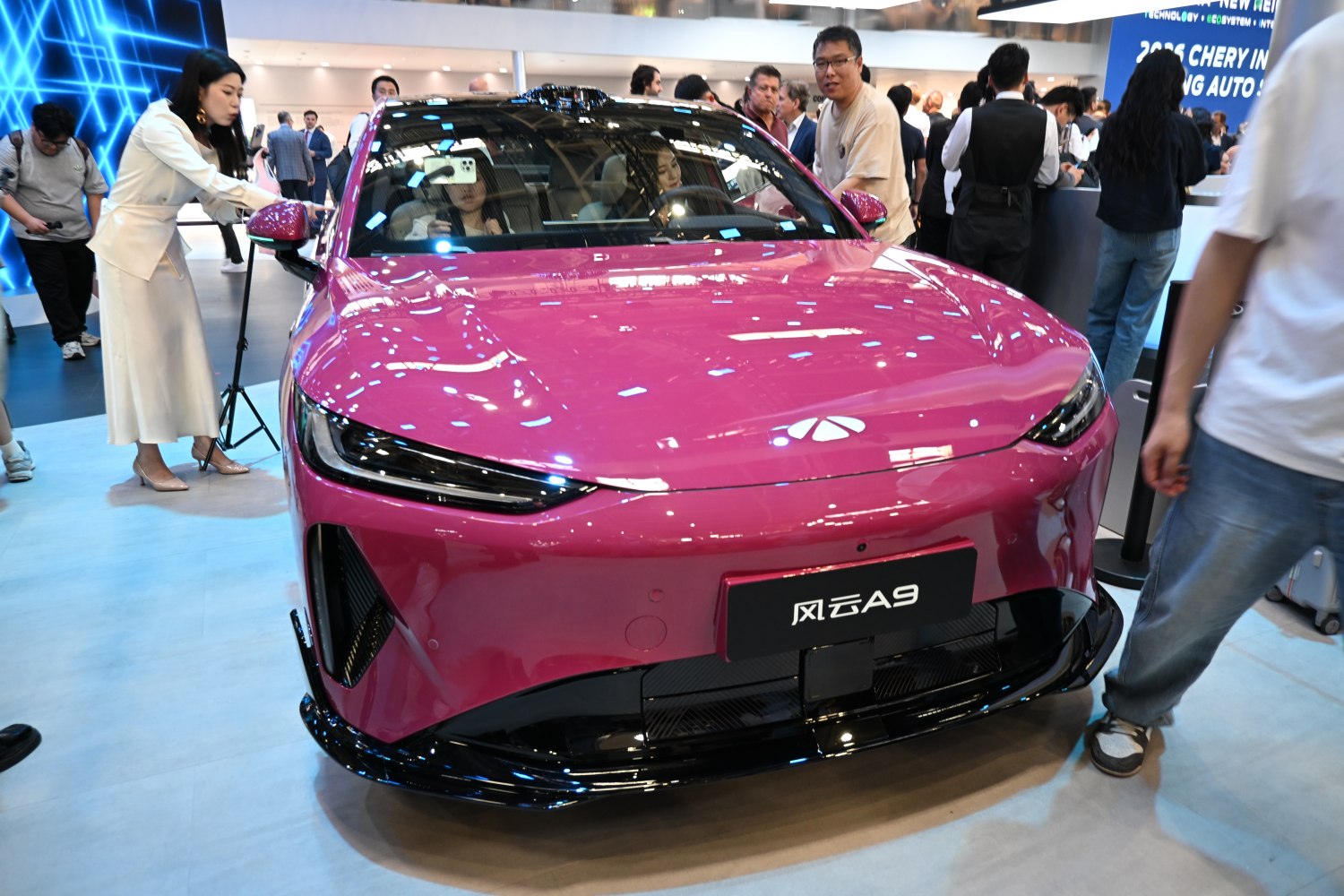 Sleek electric vehicle front with sharp LED headlights and aerodynamic design