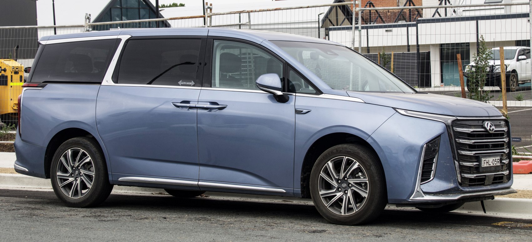 Side profile of modern minivan with automatic sliding door and alloy wheels