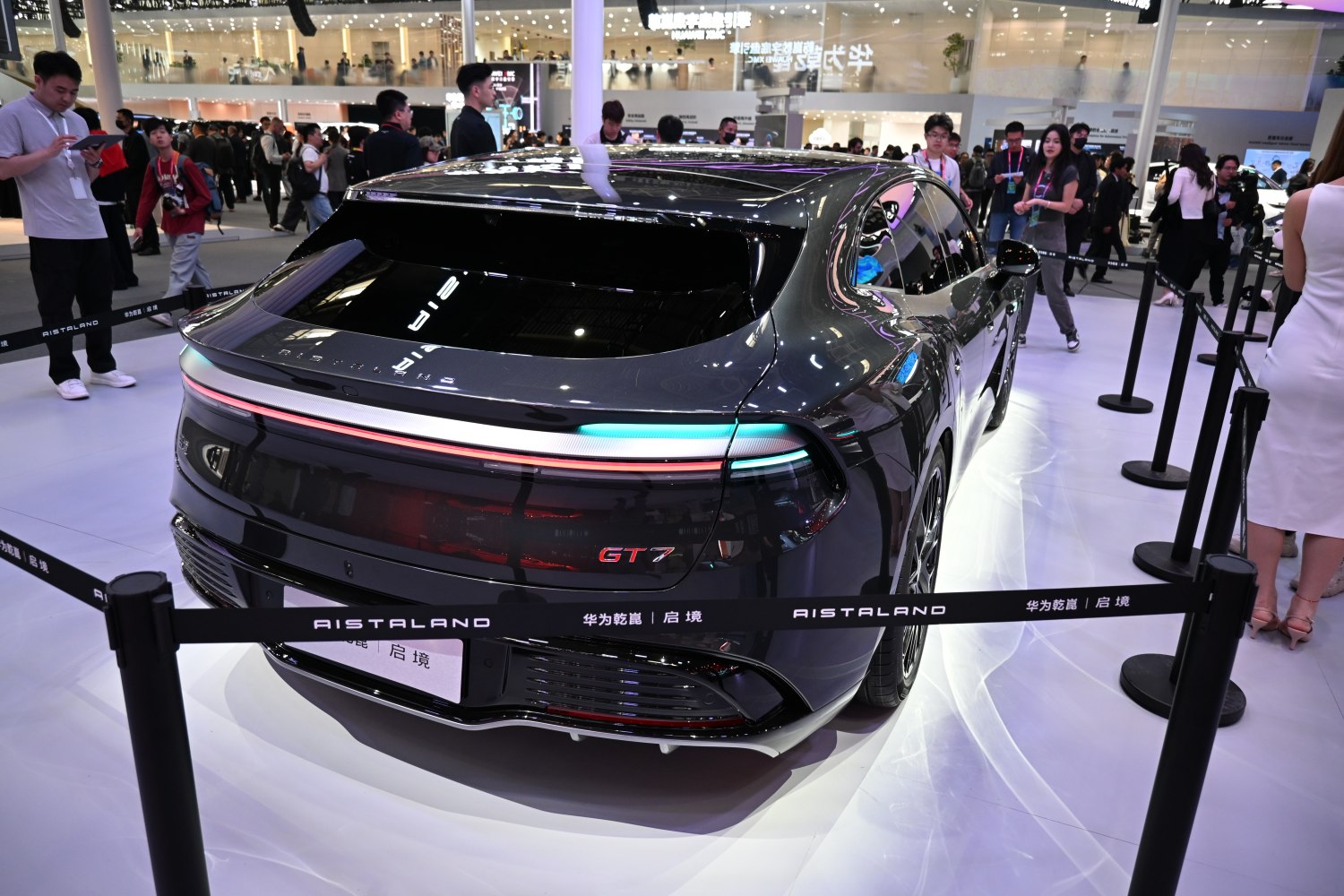 Rear car design with continuous LED light bar and GT7 badge on sleek glossy surface