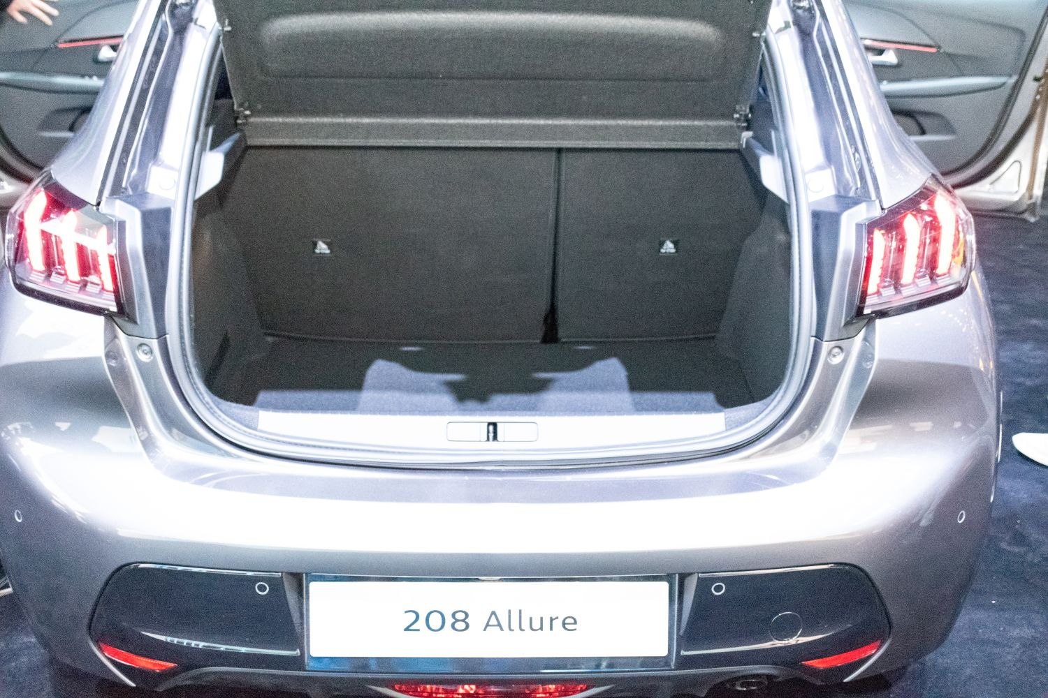 Open trunk and rear tail lights of a compact hatchback