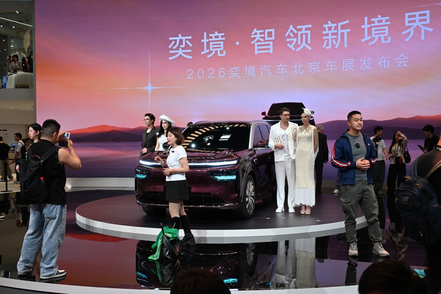 SUV with sleek design and futuristic LED front lighting on display stage