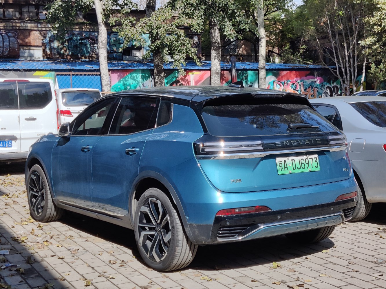 Rear-side view of blue electric SUV with distinct taillights and alloy wheels