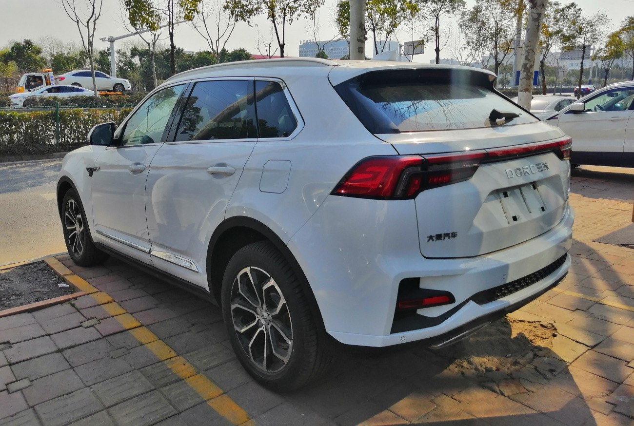 Rear and side view of a white SUV with distinct tail lights and alloy wheels.