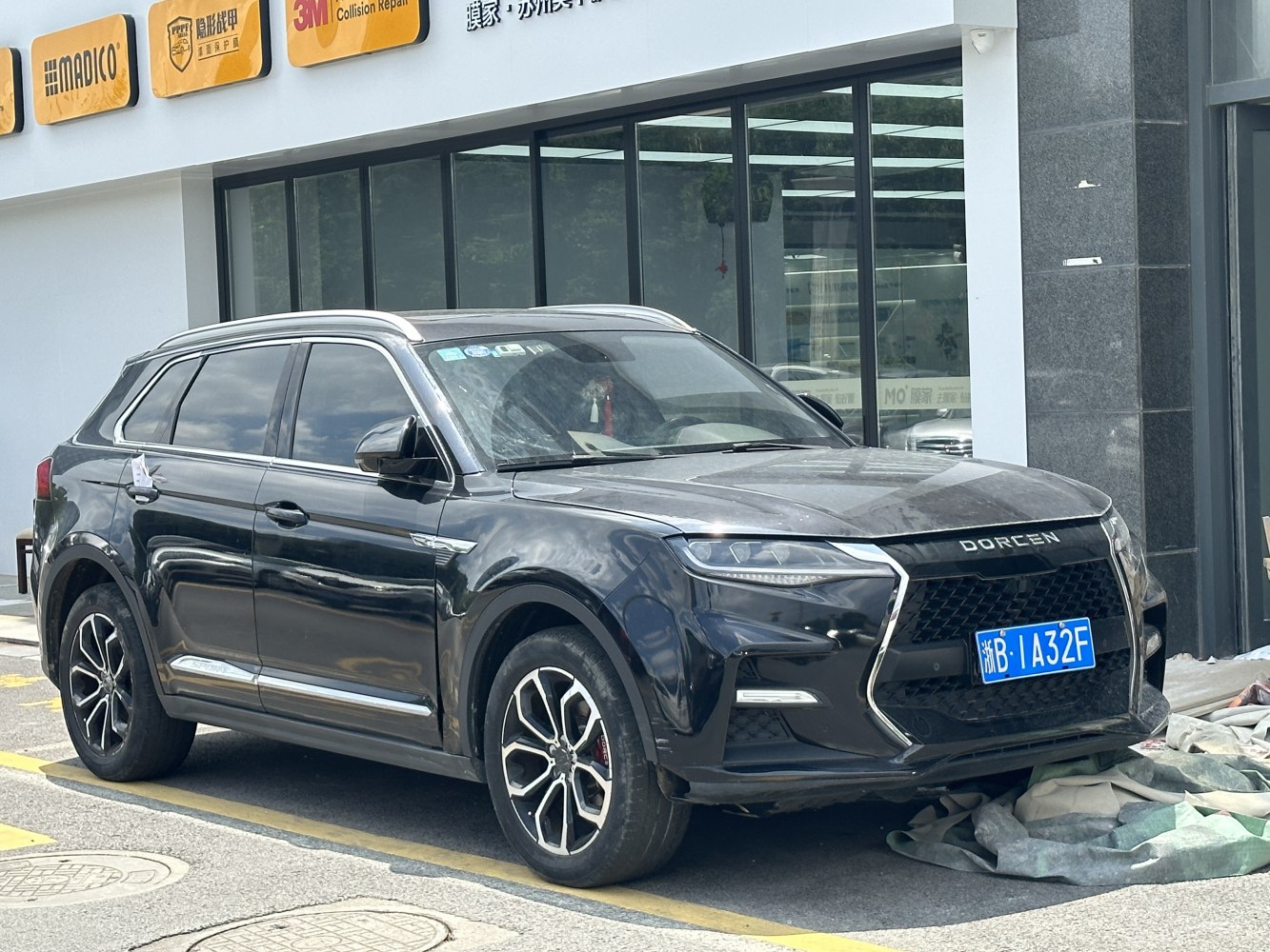 Front side view of SUV with angular grille and LED daytime running lights