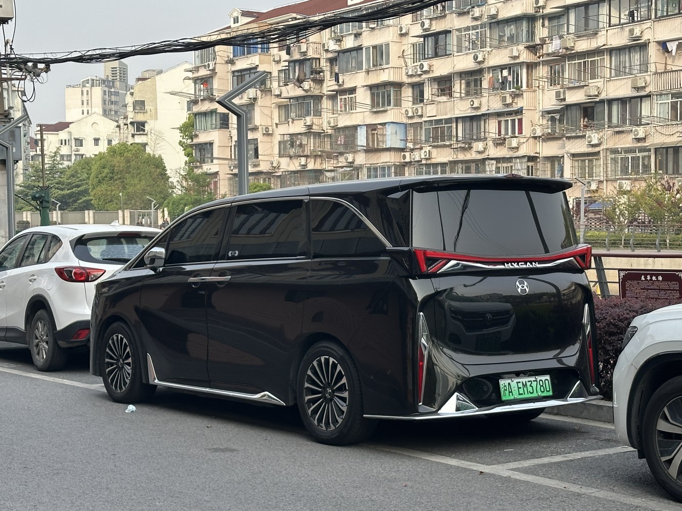 Rear view of black electric minivan with distinctive angular LED taillights