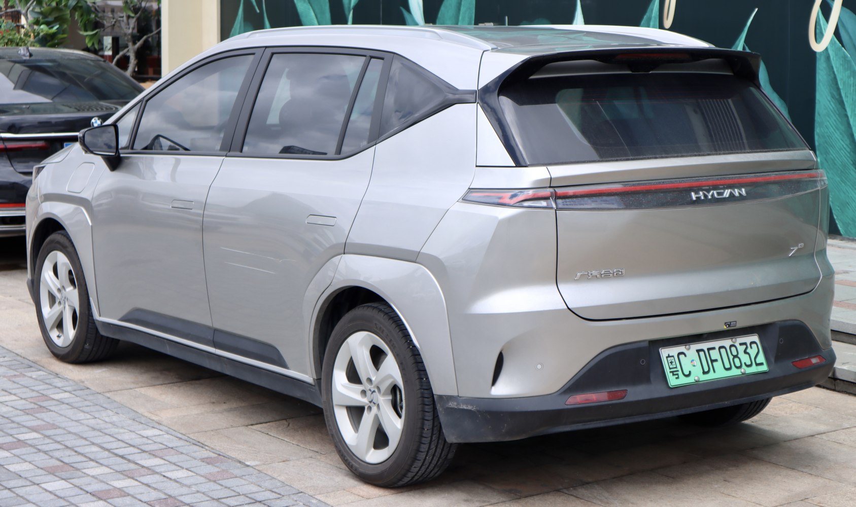 Rear side view of sleek electric SUV with integrated taillights and modern design.
