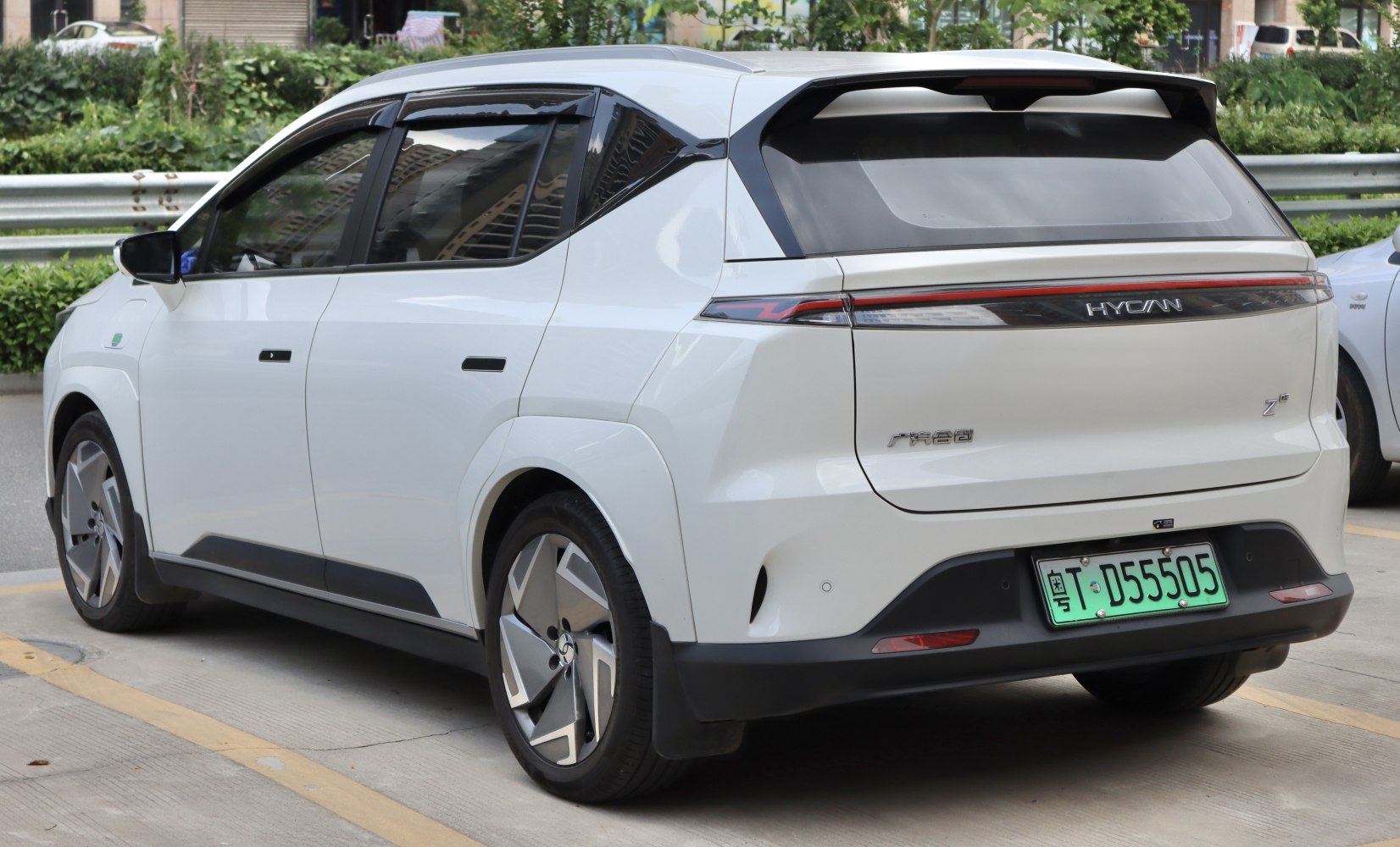 Rear view of a white electric SUV with unique tail lights and aerodynamic rear spoiler