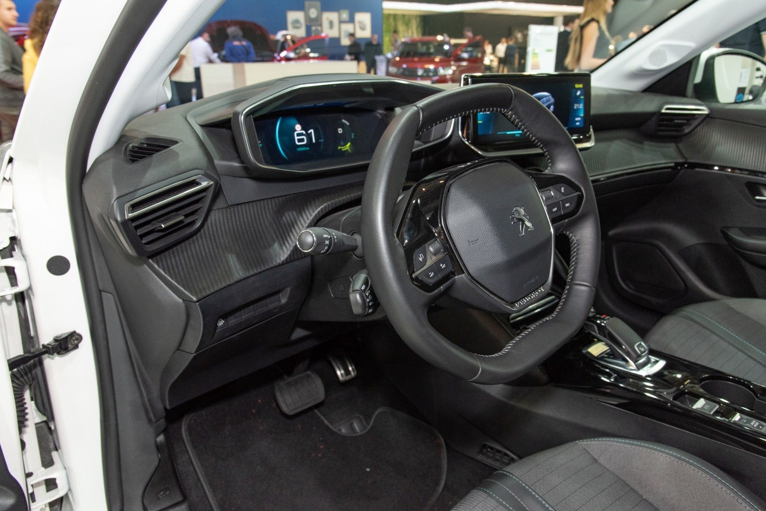 Modern digital instrument cluster with leather steering wheel and central infotainment screen