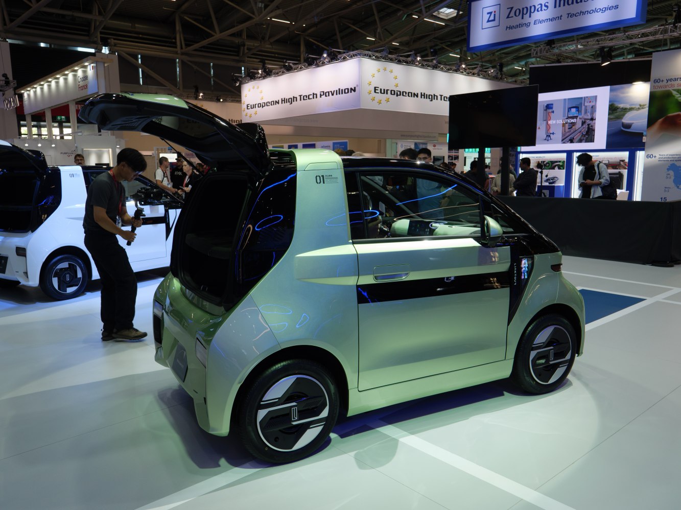 Compact electric vehicle with rear hatchback door and sleek design
