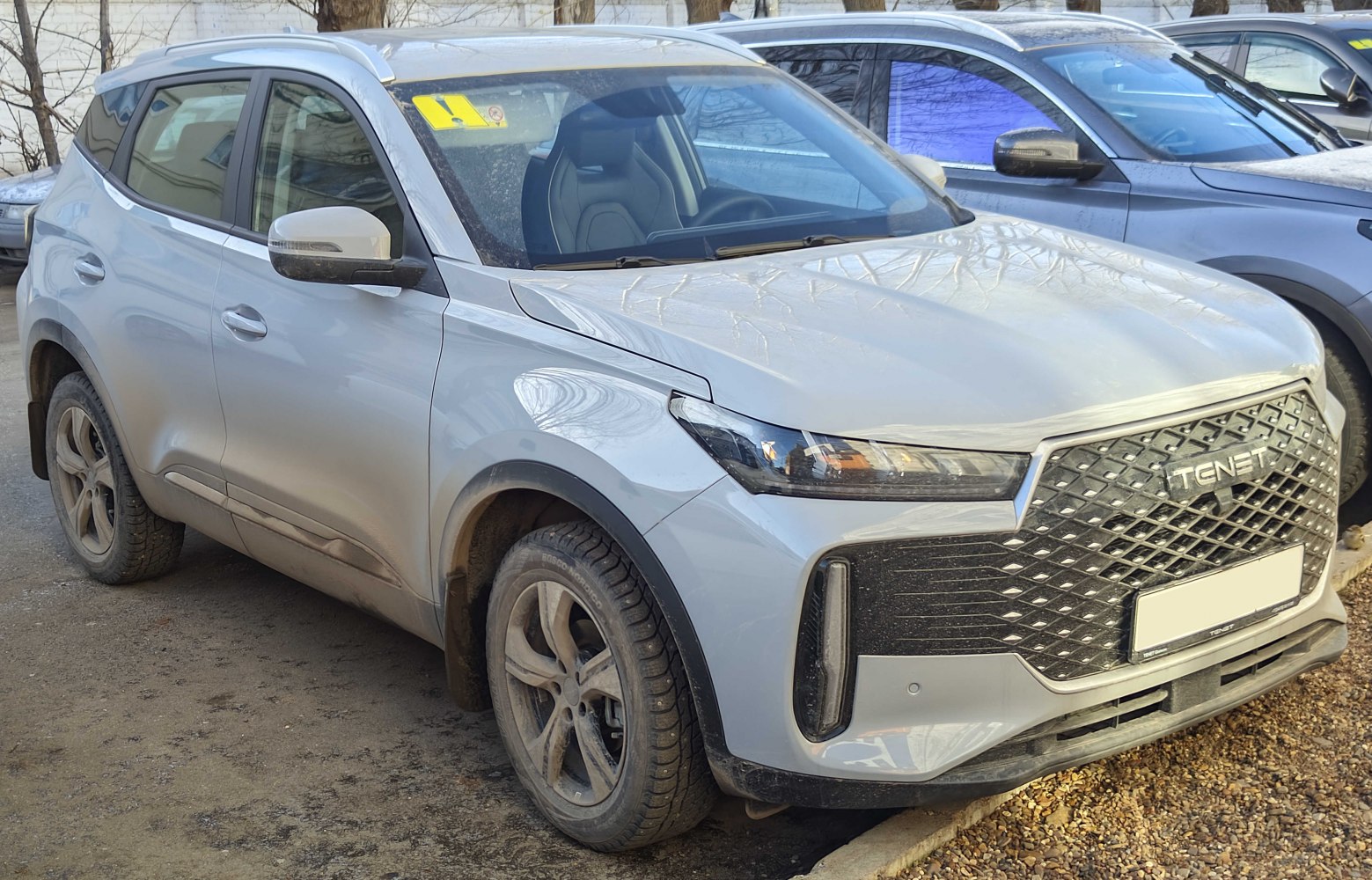 Modern compact SUV front and side view with large intricate grille
