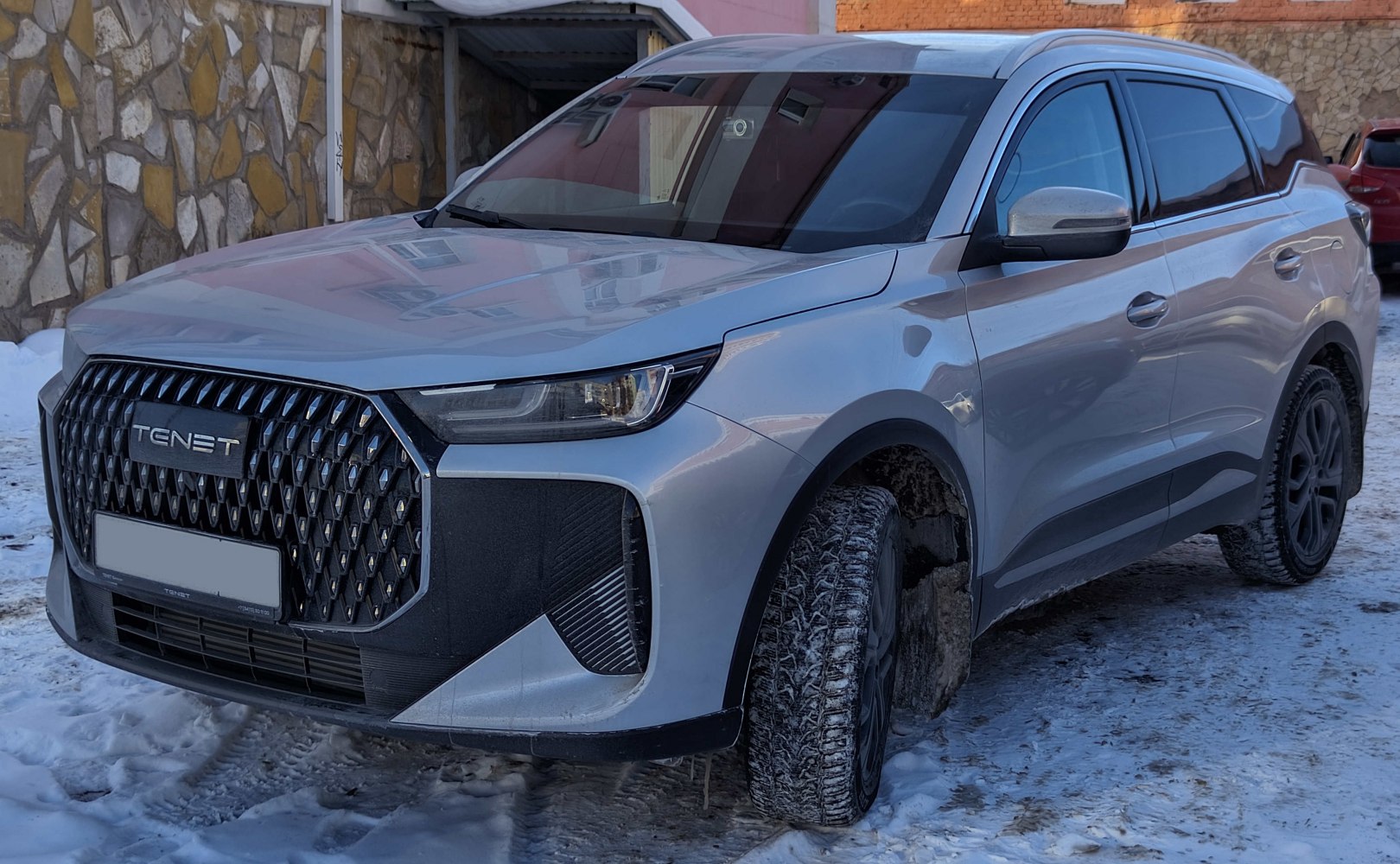 Modern SUV with large patterned grille and sleek angular headlights