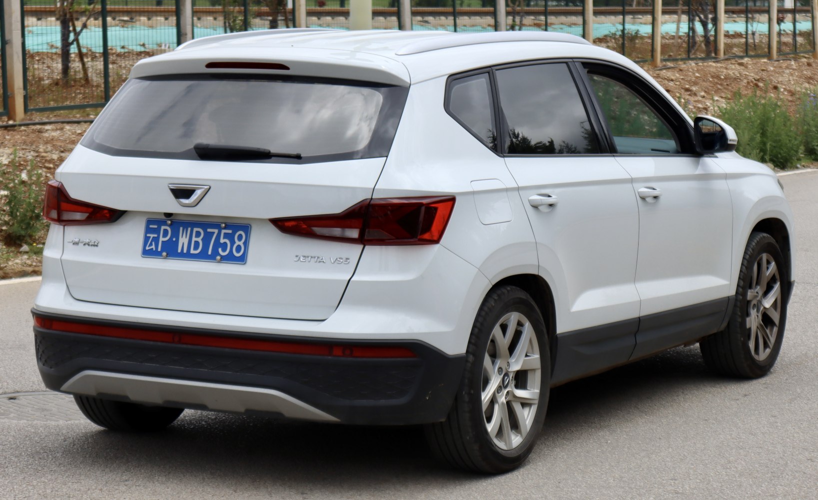 Rear and side profile showing taillights and alloy wheels.