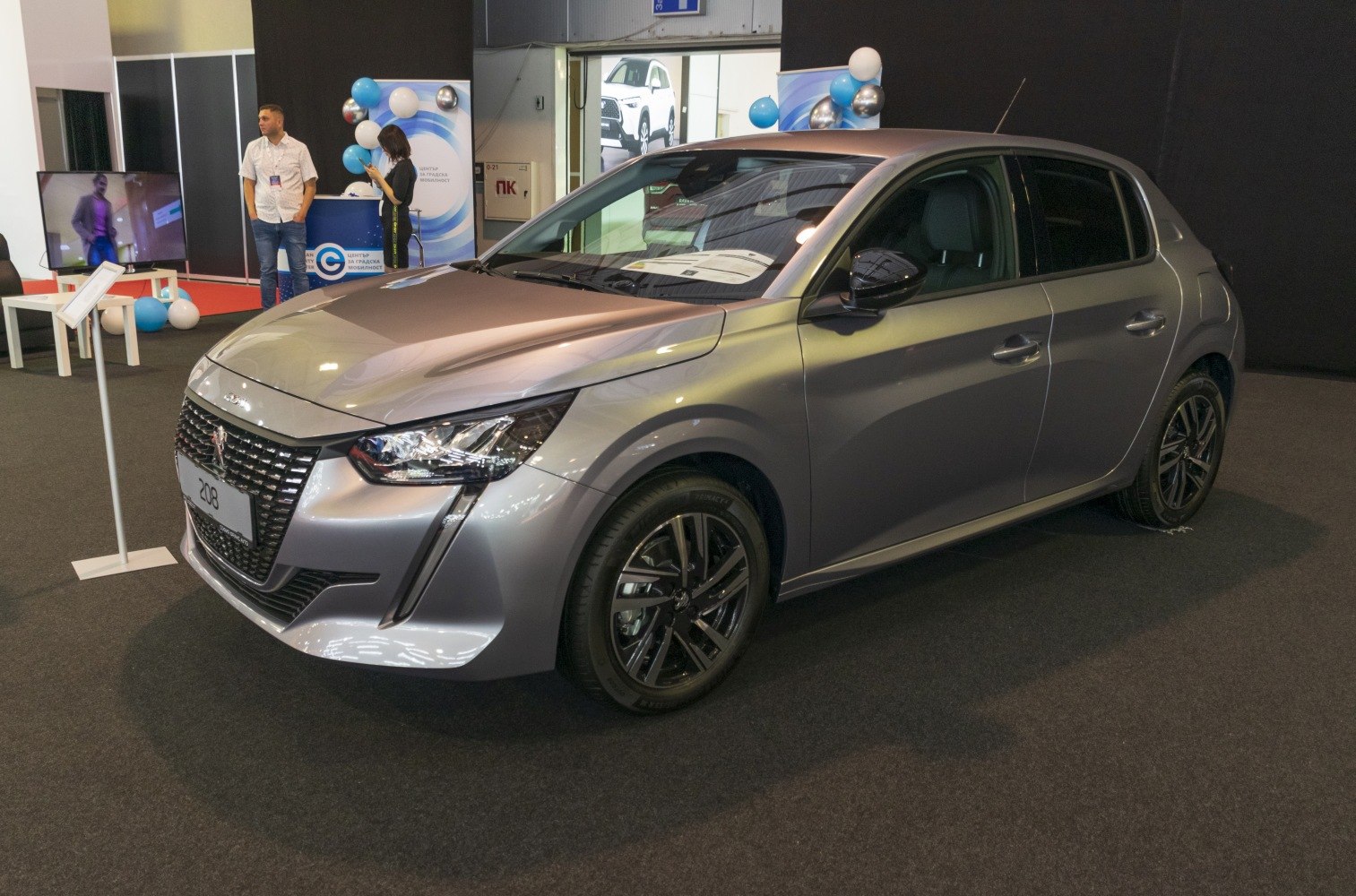 Front and side view of a compact hatchback with distinctive headlights and alloy wheels