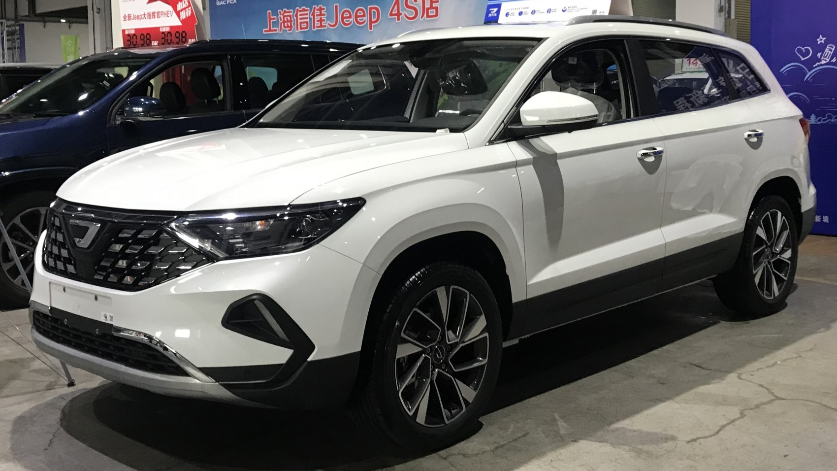 White mid-size SUV with black grille and alloy wheels