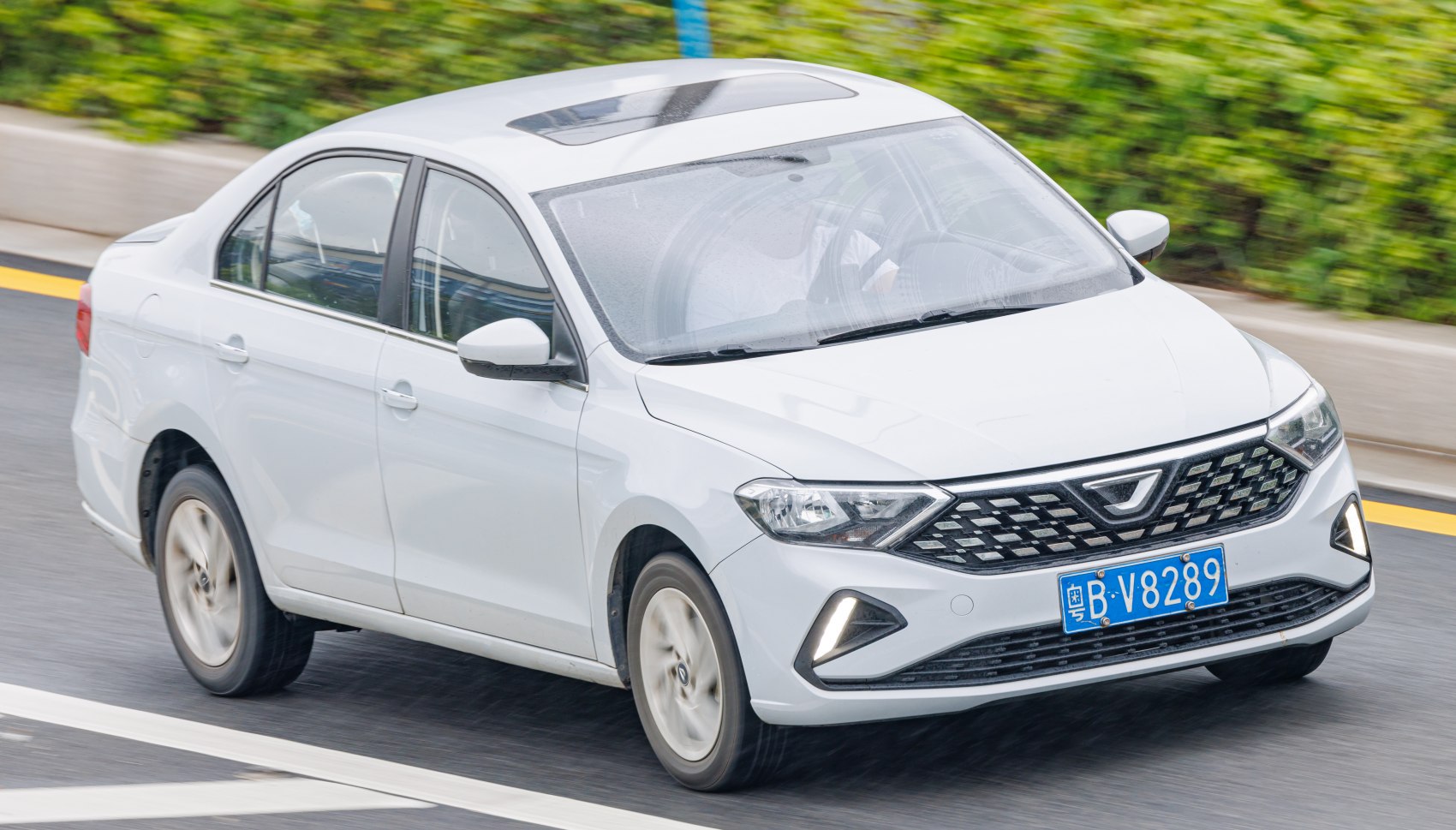 Front angle of sedan with diamond grille and LED daytime running lights