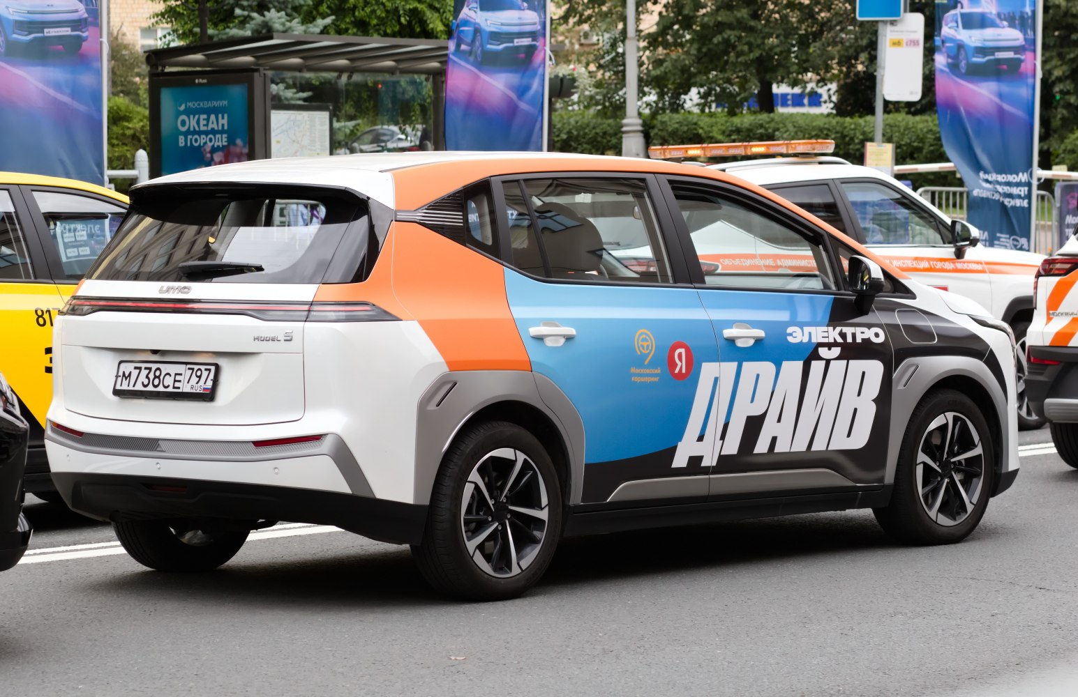Multicolor electric hatchback with modern rims and urban street background