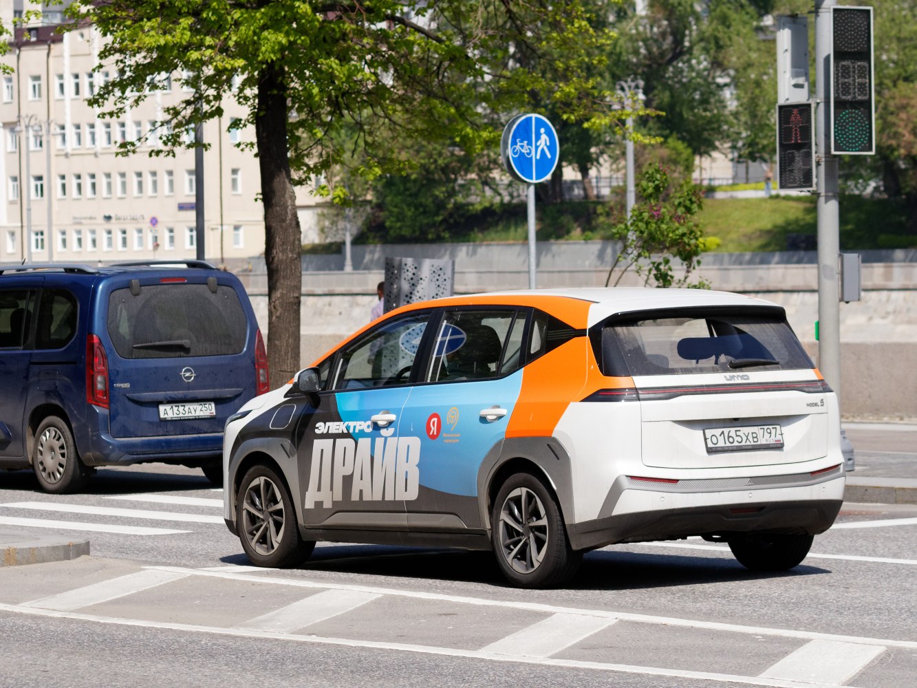 Rear-side view of electric hatchback with colorful design and unified rear light strip.