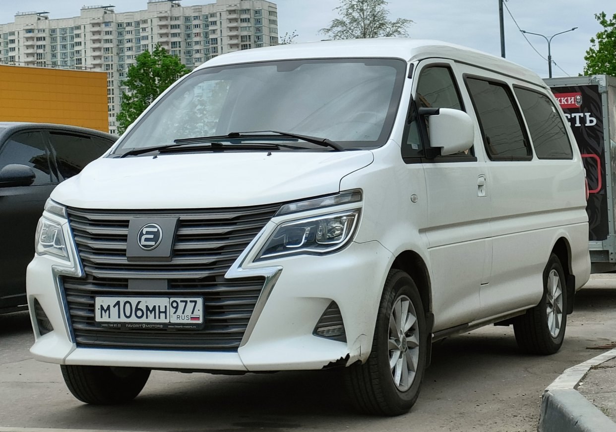 Front view of a white van with bold grille and LED headlights